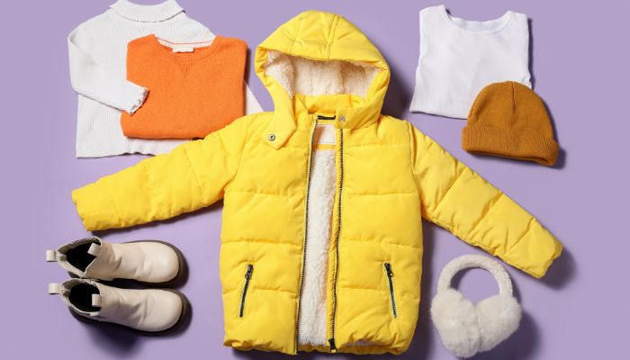 Winter kids clothes flat lay with jacket, boots, and accessories.
