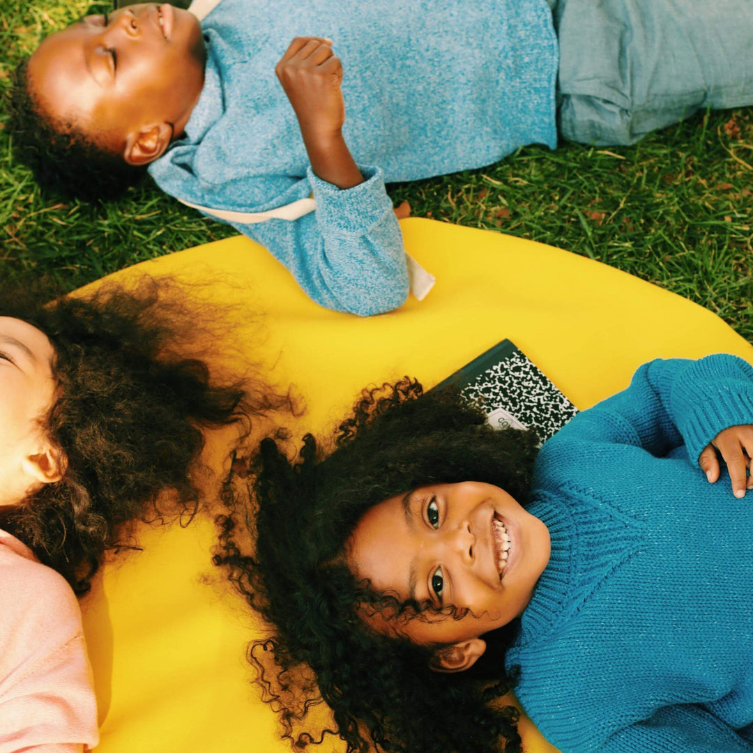 Smiling children outdoors wearing colorful kids sweaters