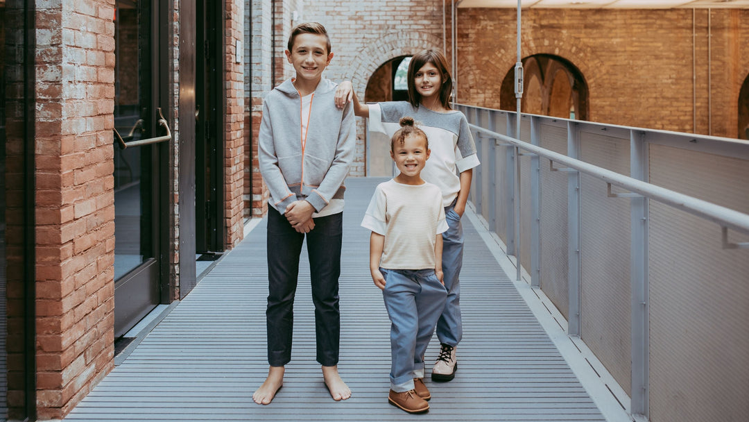 Three children wearing Quality Kids' Clothes from Firebird Kids