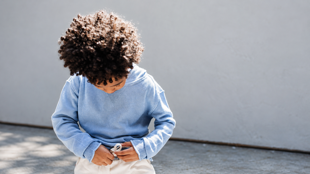 A kid wearing Soft Blue Cotton-Cashmere Hoodie Sweater by Firebird Kids