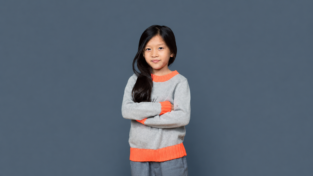 A kid wearing a Colorblock Crewneck Sweater by Firebird Kids