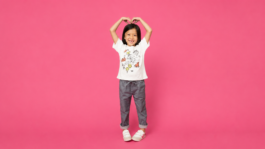 A girl wearing a graphic tee painted by Firebird Kids