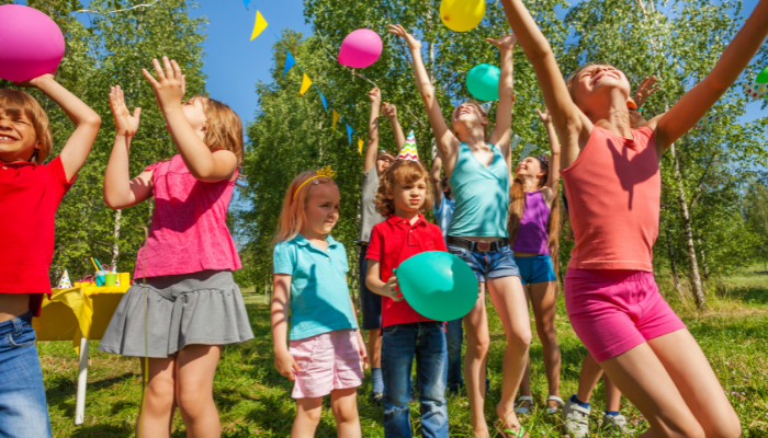 Kids playing outdoors in lightweight summer clothes during hot weather