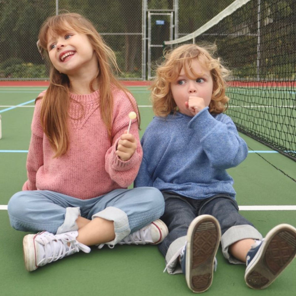 Firebird Kids Light Wash Denim Pants, worn by a girl, styled with a sweater.