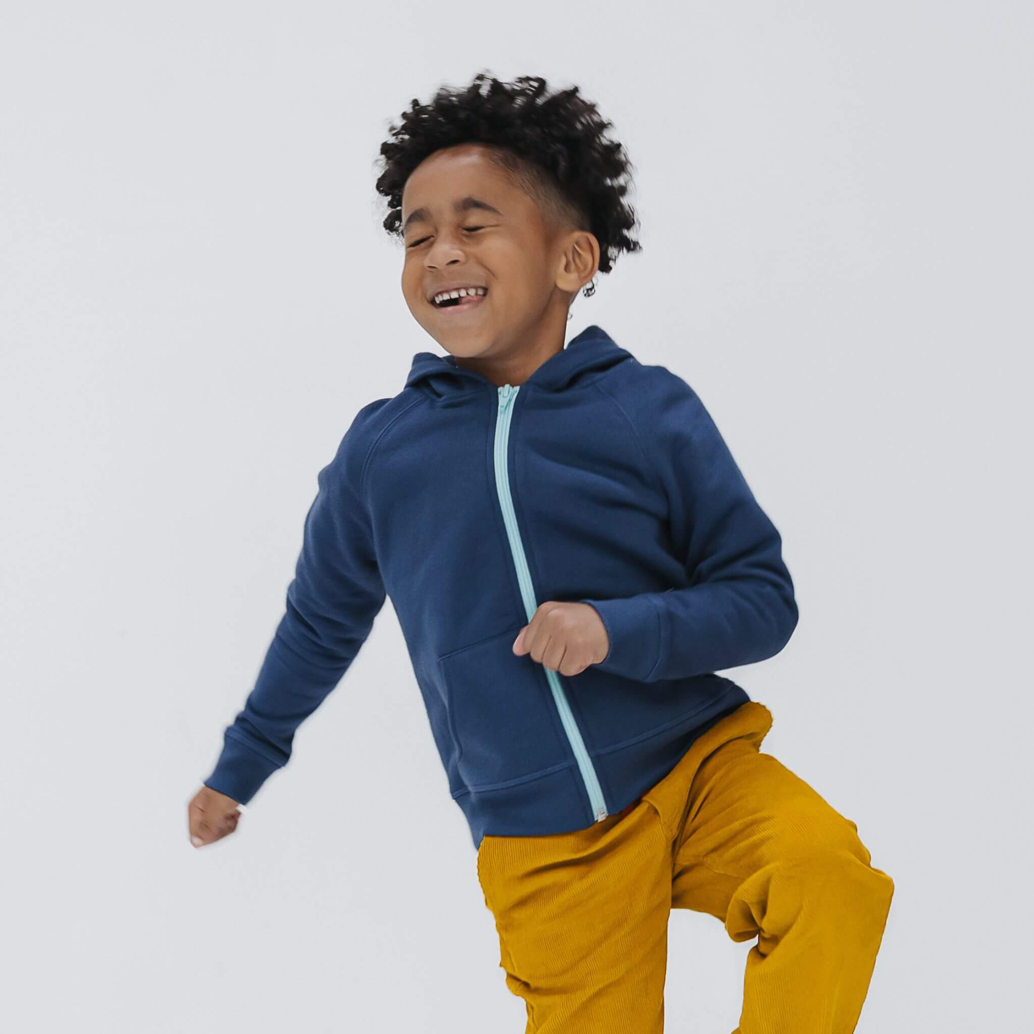 Boy wearing the Firebird Kids navy organic cotton fleece zip hoodie