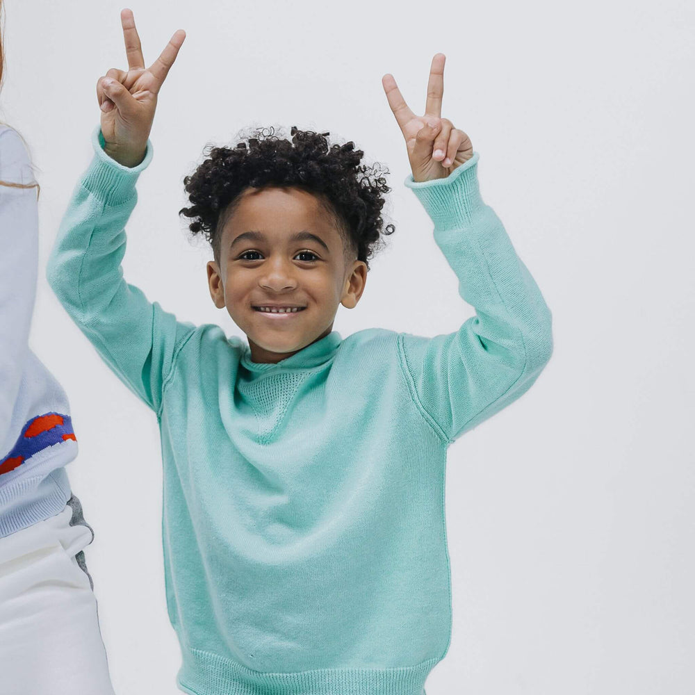 Boy wearing a lightweight Sea Glass Blue cashmere-blend hoodie