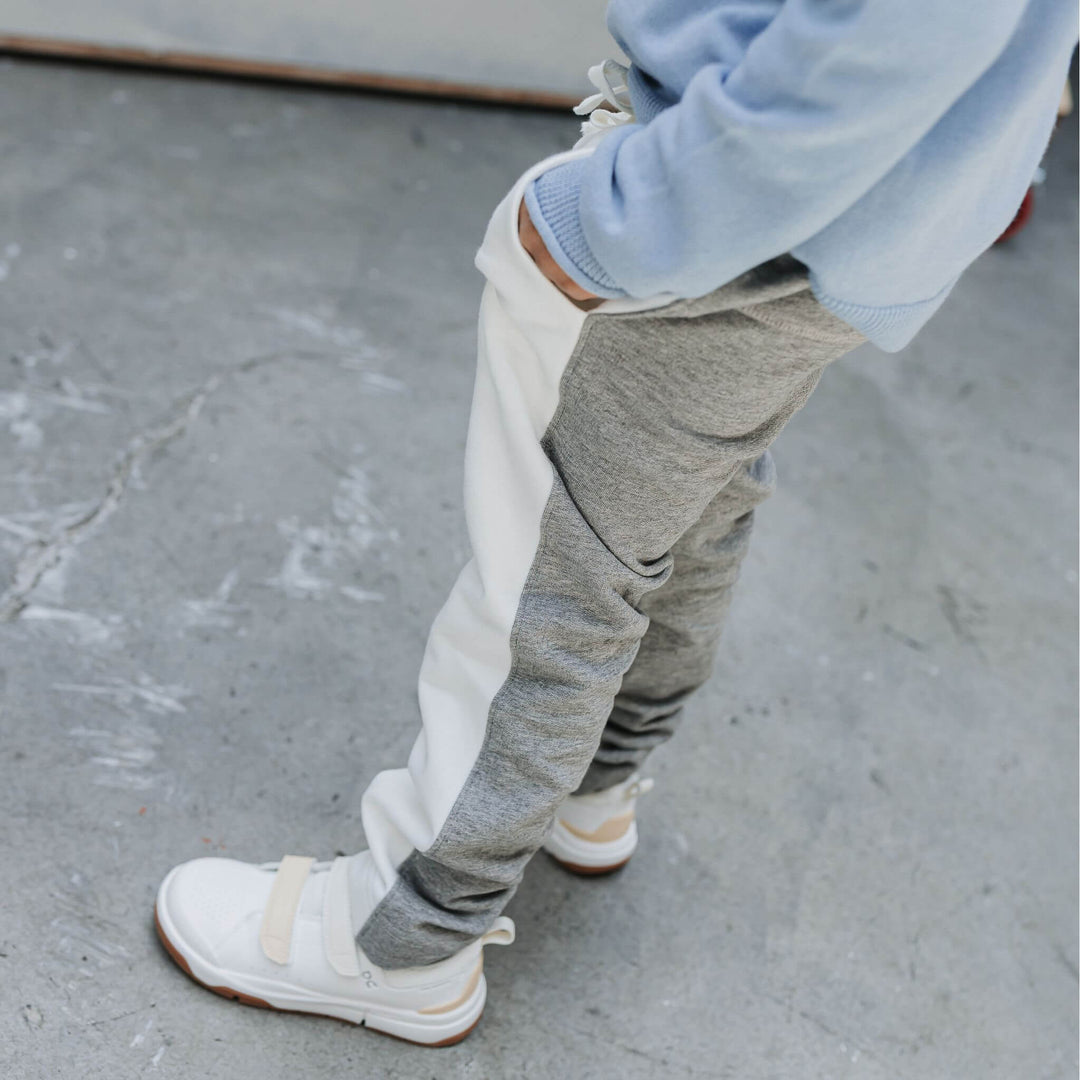 Boy wearing heather gray and ivory colorblock sweatpants