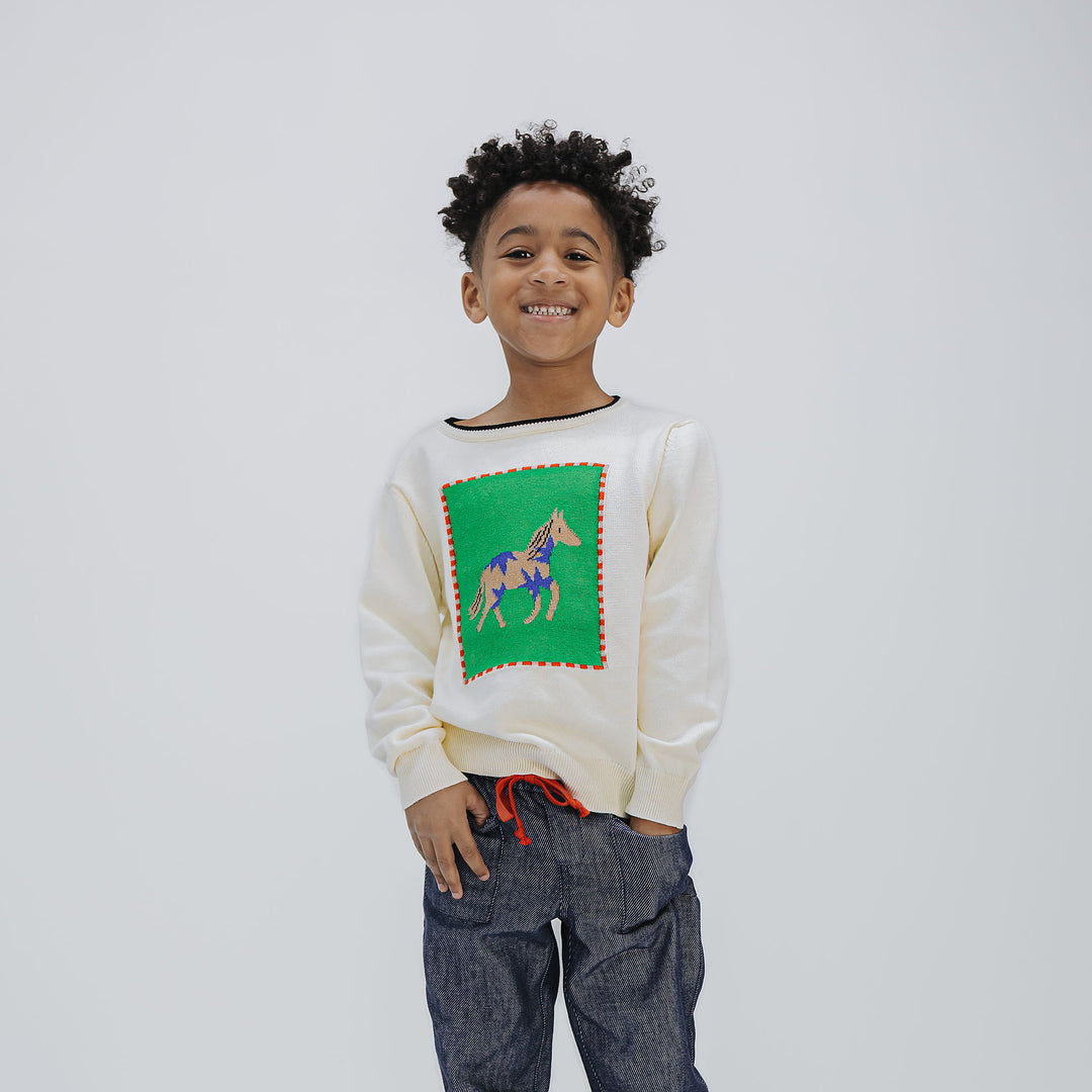 Boy in the unisex Horse Intarsia Sweater with dark denim, three-quarter length