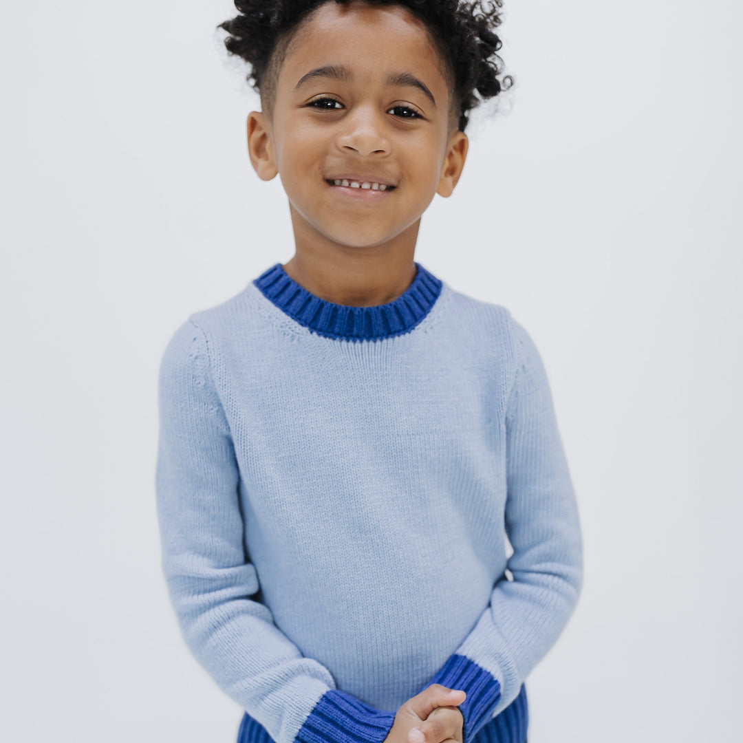 Kids colorblock crewneck sweater in light blue with cobalt contrast trim, organic cotton, knit in New York, front view on a boy