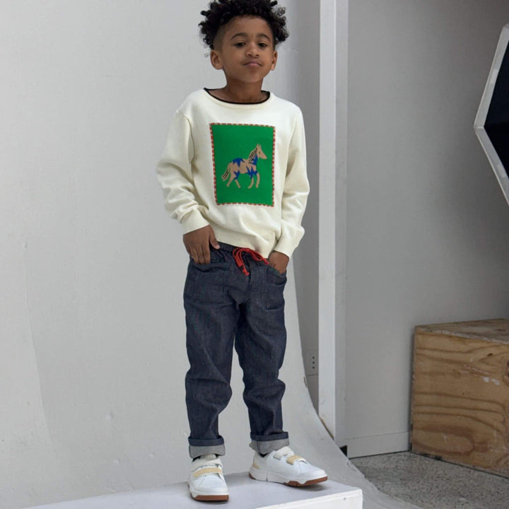 Boy wearing dark navy Firebird Studio Denim Pants in organic Japanese denim, front view
