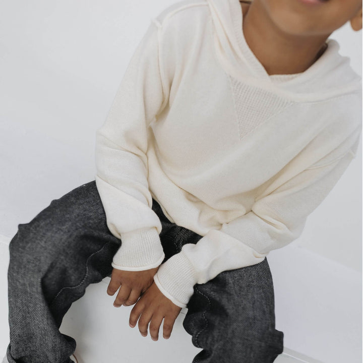 Front view of the Firebird Kids ivory cotton-cashmere hoodie sweater on a boy 