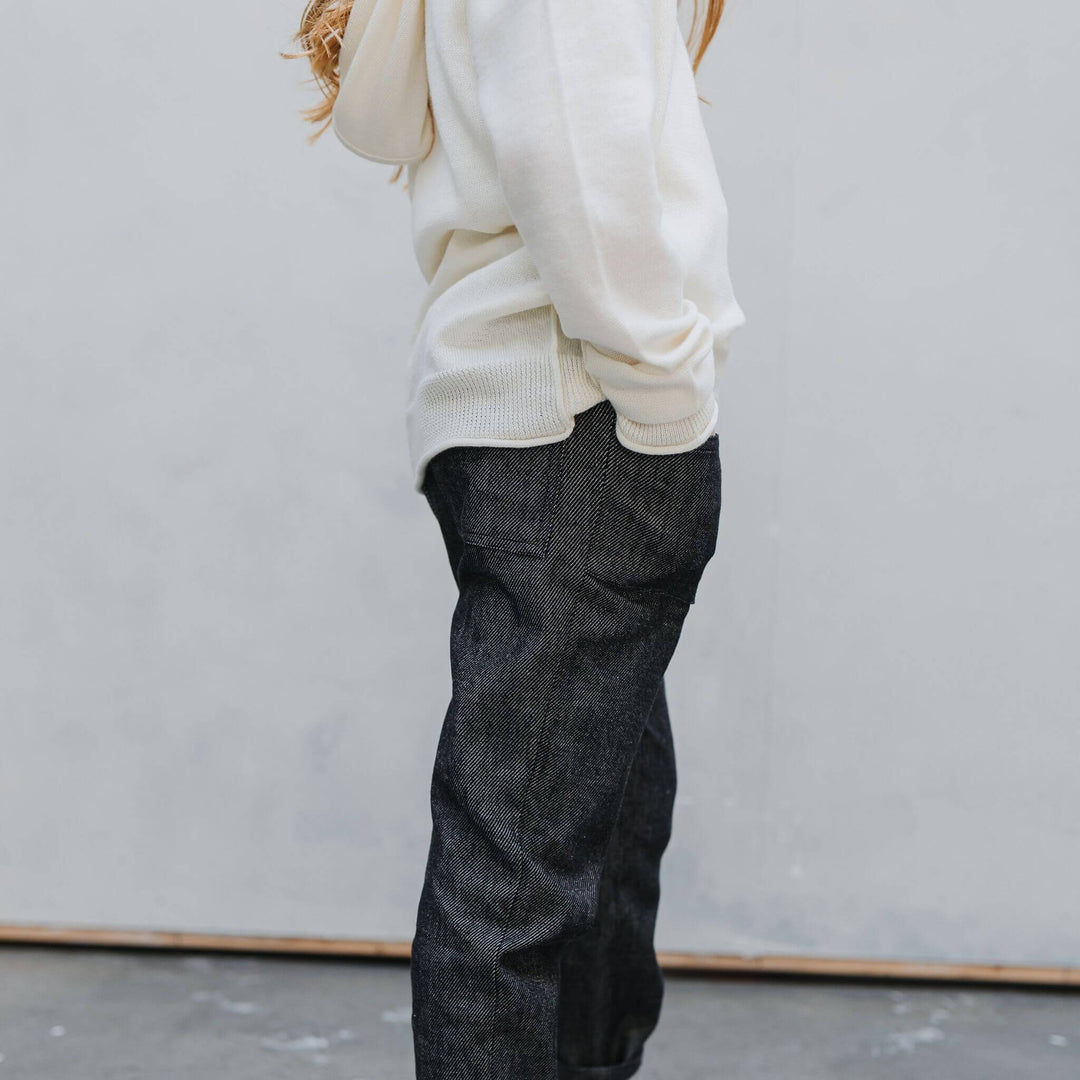 Side view of the Firebird Kids ivory cotton-cashmere hoodie sweater on a girl
