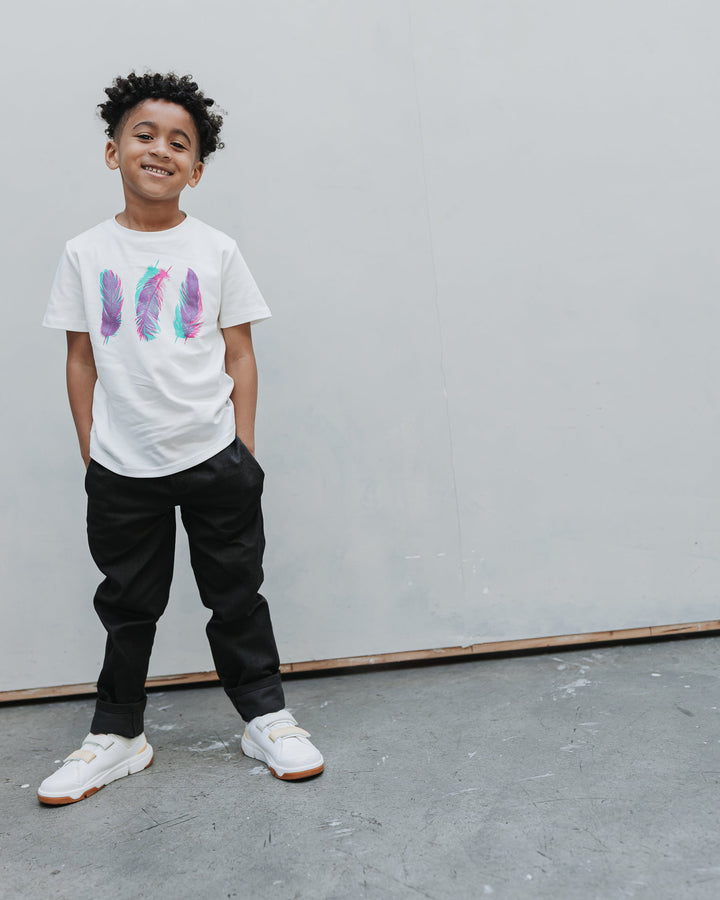 Boy wearing the Firebird Kids Vintage Drill Pant in black with a white graphic tee, full length front view