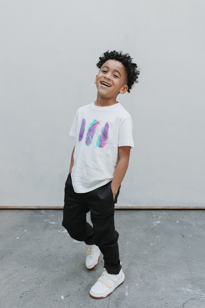 Boy laughing with hands in the front pockets of black straight-leg drill pants