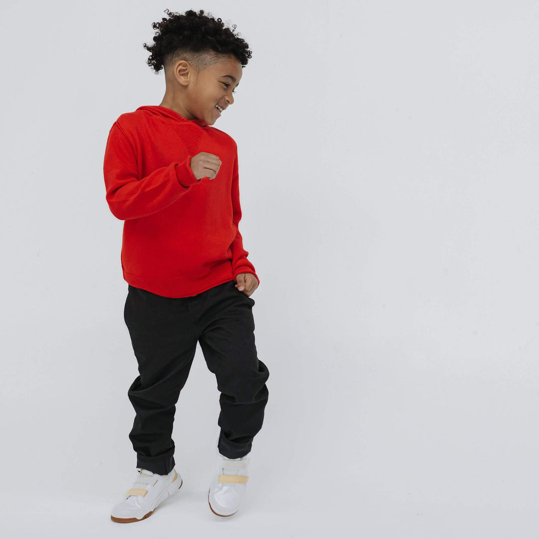 Boy wearing black Firebird vintage drill pant and red cashmere cotton hoodie