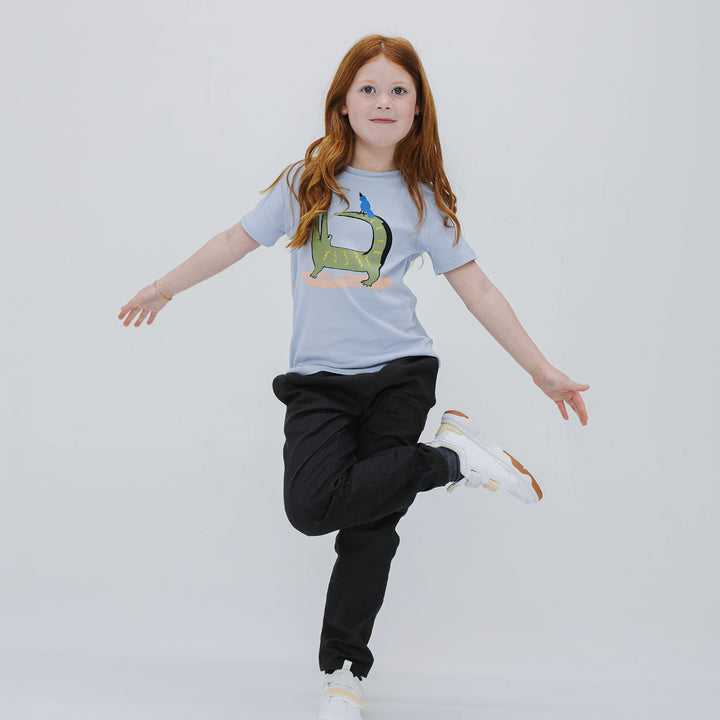 Girl wearing the Firebird Kids powder blue organic cotton graphic tee
