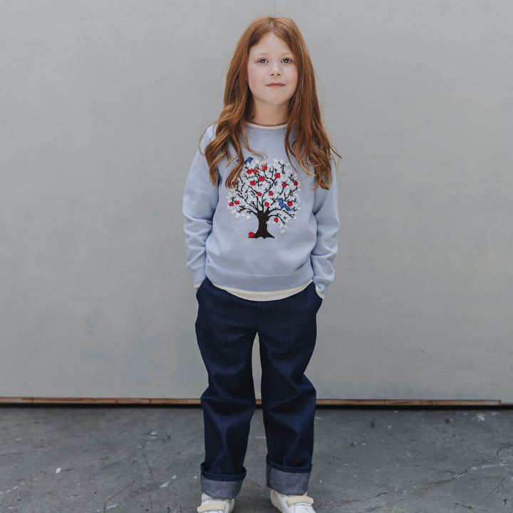 Girl wearing the Firebird Kids organic cotton tree sweater