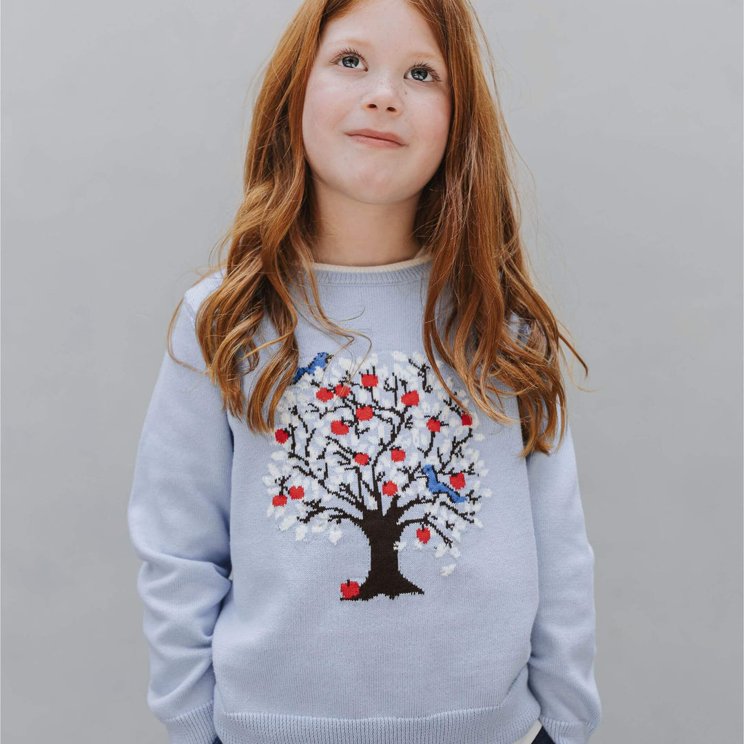 Close-up of the tree intarsia design on the dusty blue kids sweater