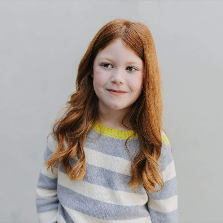 Girl wearing the Firebird Kids yellow striped organic cotton crewneck sweater 