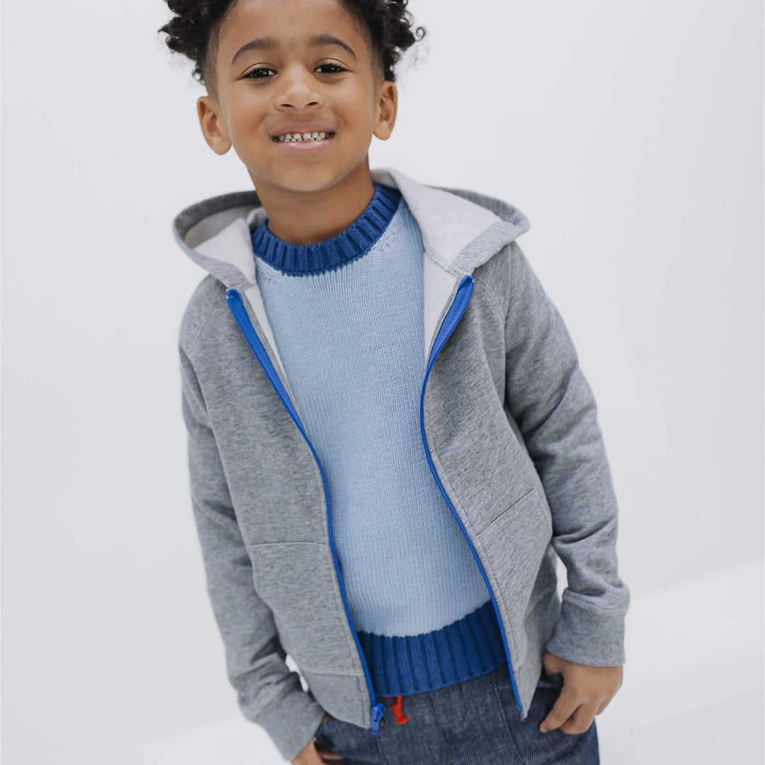 Child wearing the Firebird Kids heather gray organic cotton fleece zip hoodie