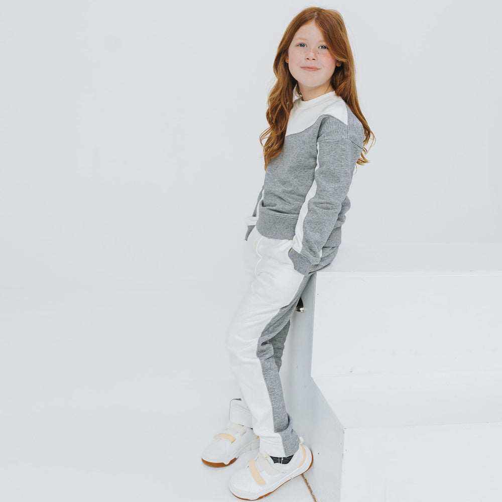 Girl wearing the Firebird Kids organic cotton fleece joggers