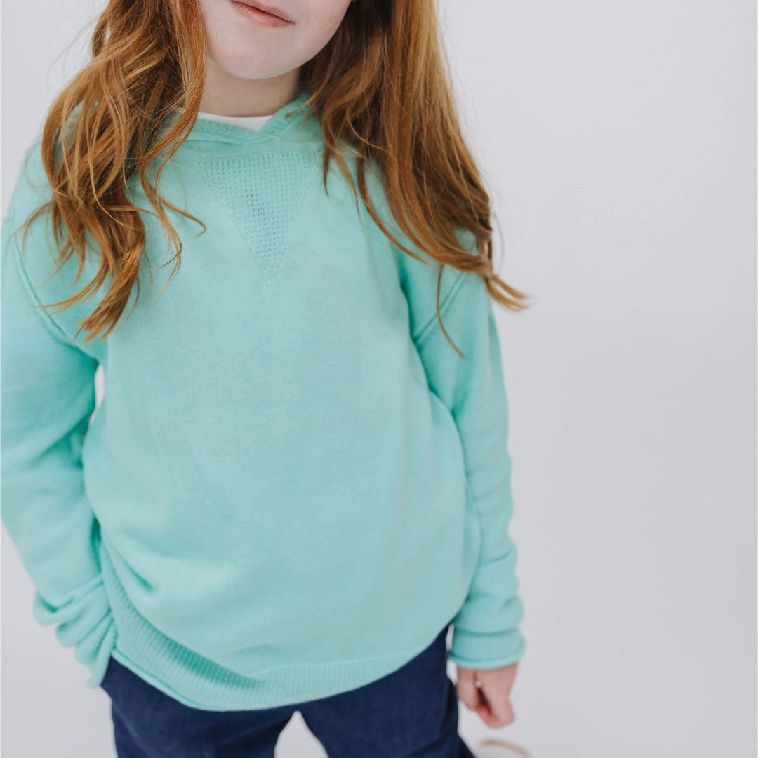 Girl in a lightweight Sea Glass Blue cashmere-blend hoodie
