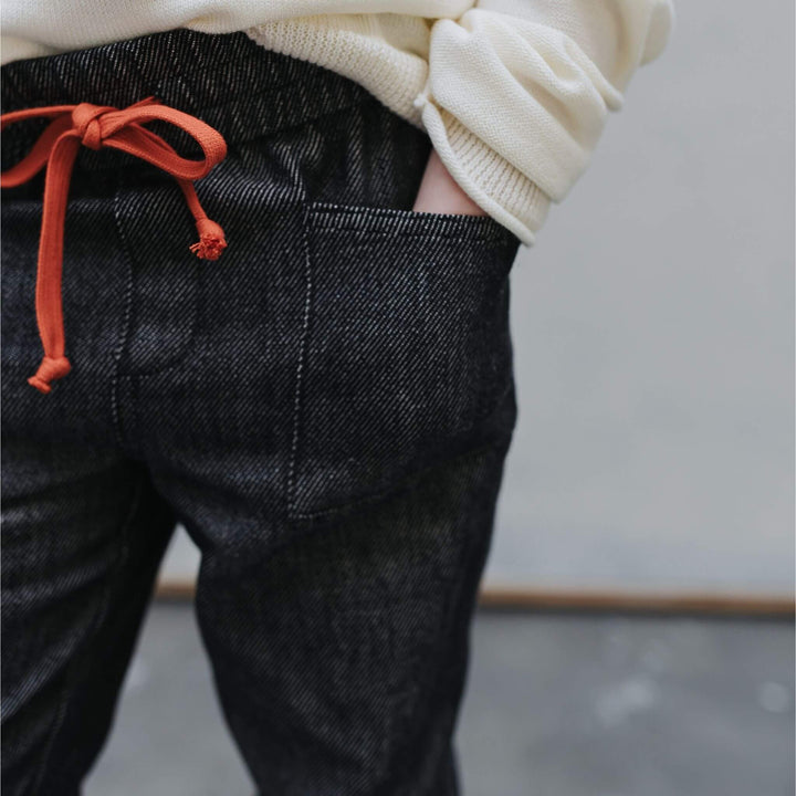 Texture close-up of black soft organic Japanese denim used in Firebird Studio Denim Pants