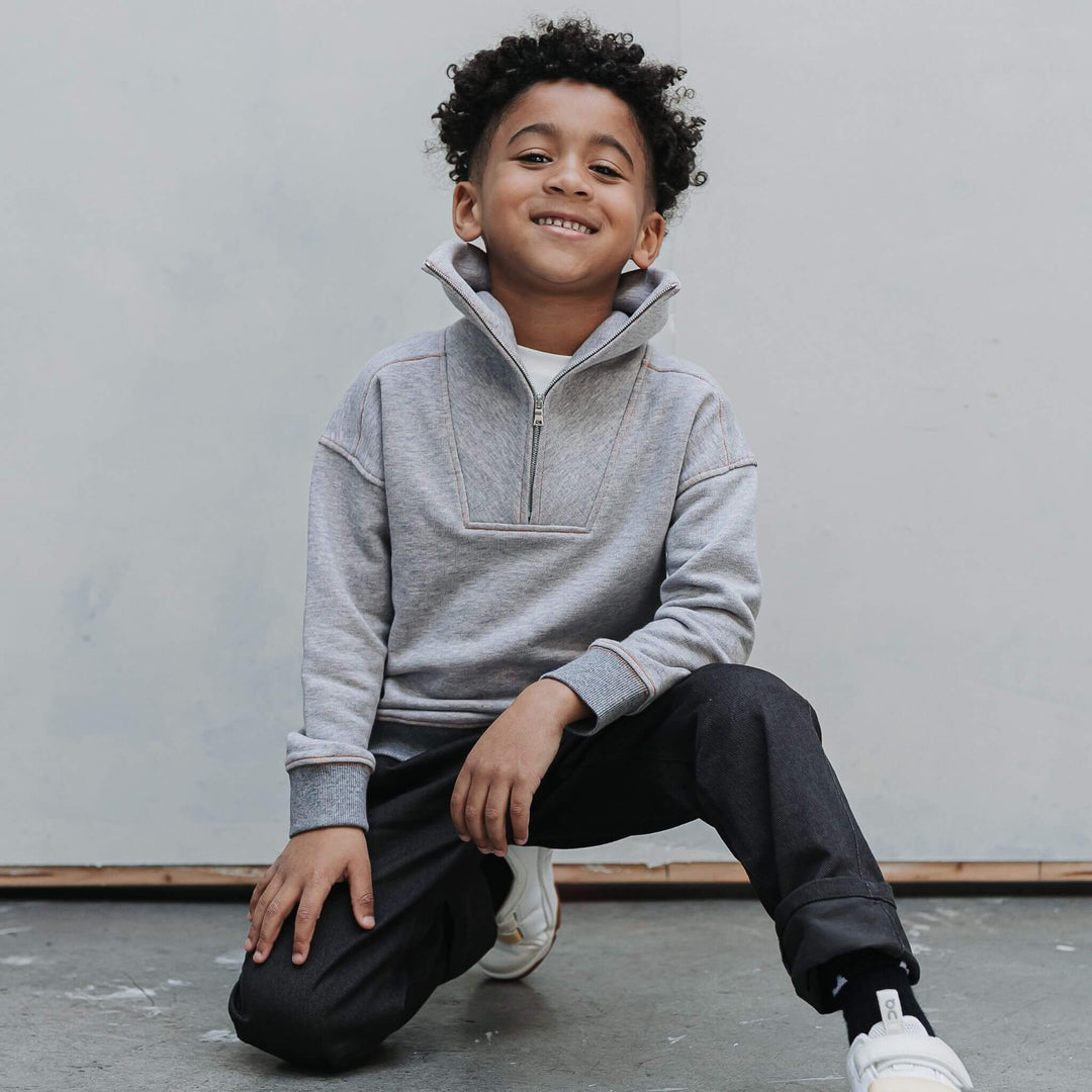 Mockneck collar and zipper on the gray organic cotton half-zip sweatshirt on a boy 
