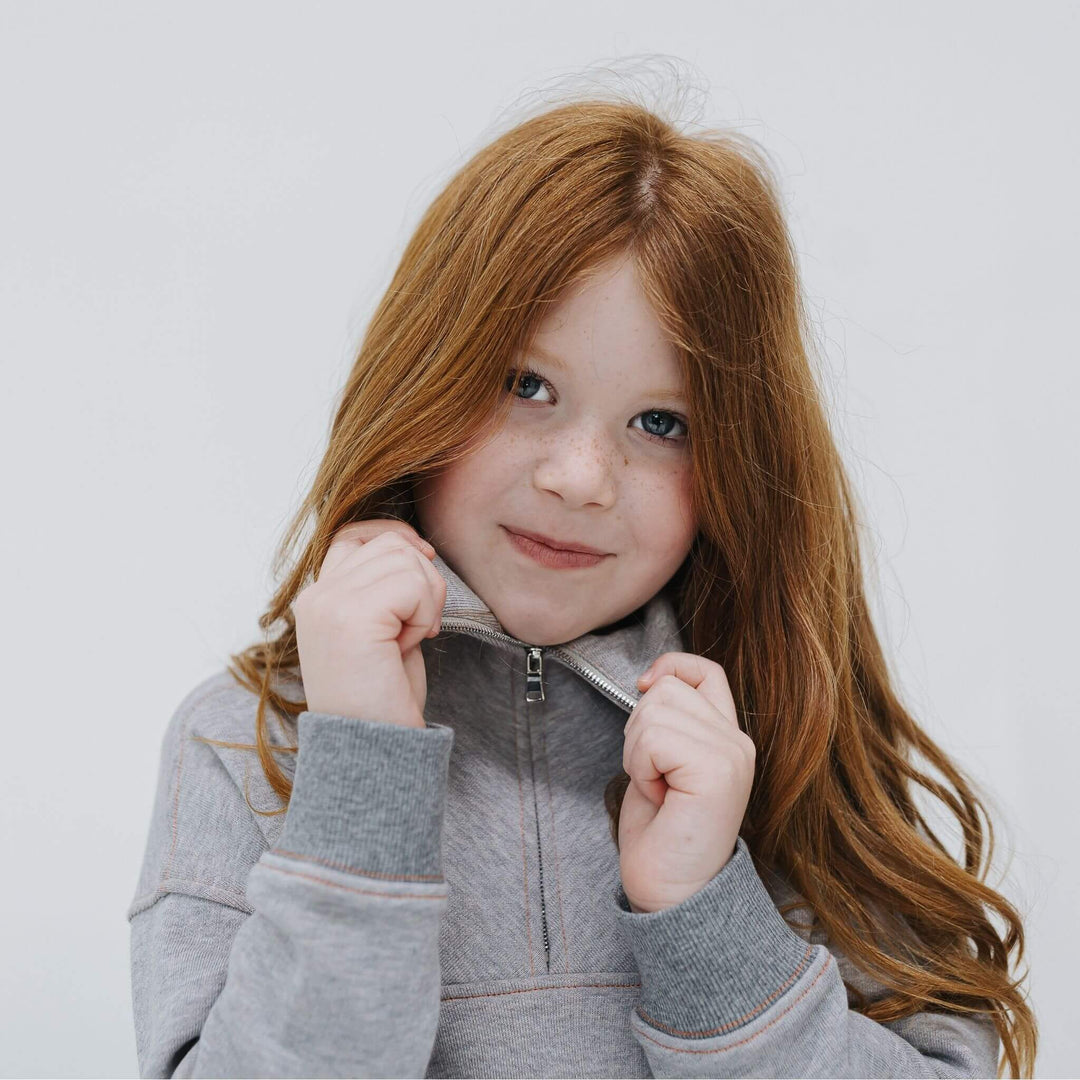 Girl wearing mockneck half zip sweatshirt 