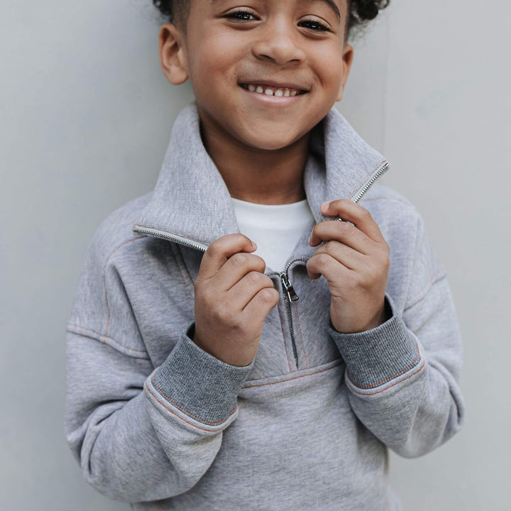Boy wearing mockneck half zip sweatshirt 