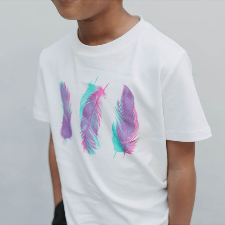Close-up of the colorful feather print on the Three Feathers organic Pima cotton tee