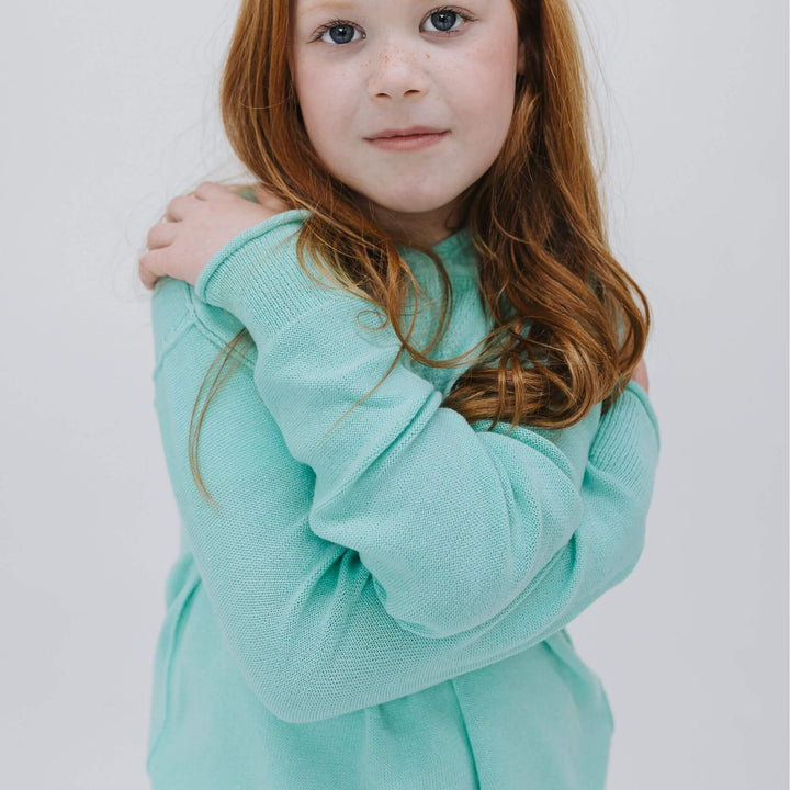Girl wearing the Sea Glass Blue cotton-cashmere hoodie sweater