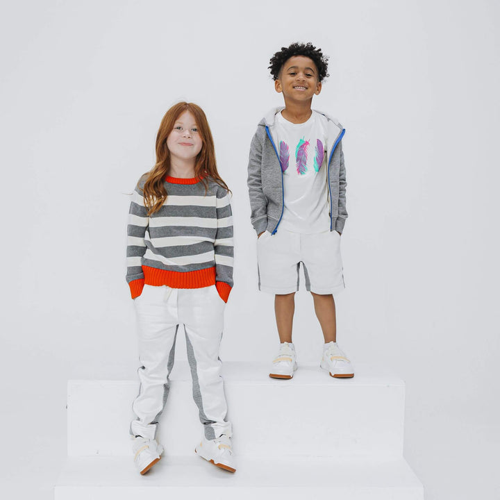 Girl wearing heather gray and ivory colorblock sweatpants