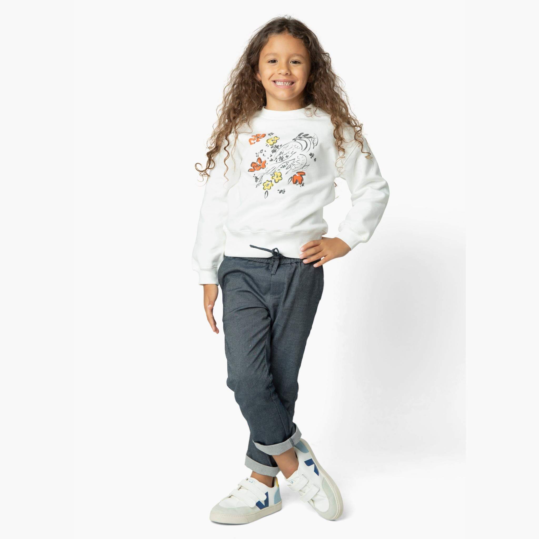 Girl wearing the perfect jean from our Kids Essentials collection. Soft Denim Pants in Dark Gray, cuffed for a polished yet fun look, made of 100% organic Japanese cotton