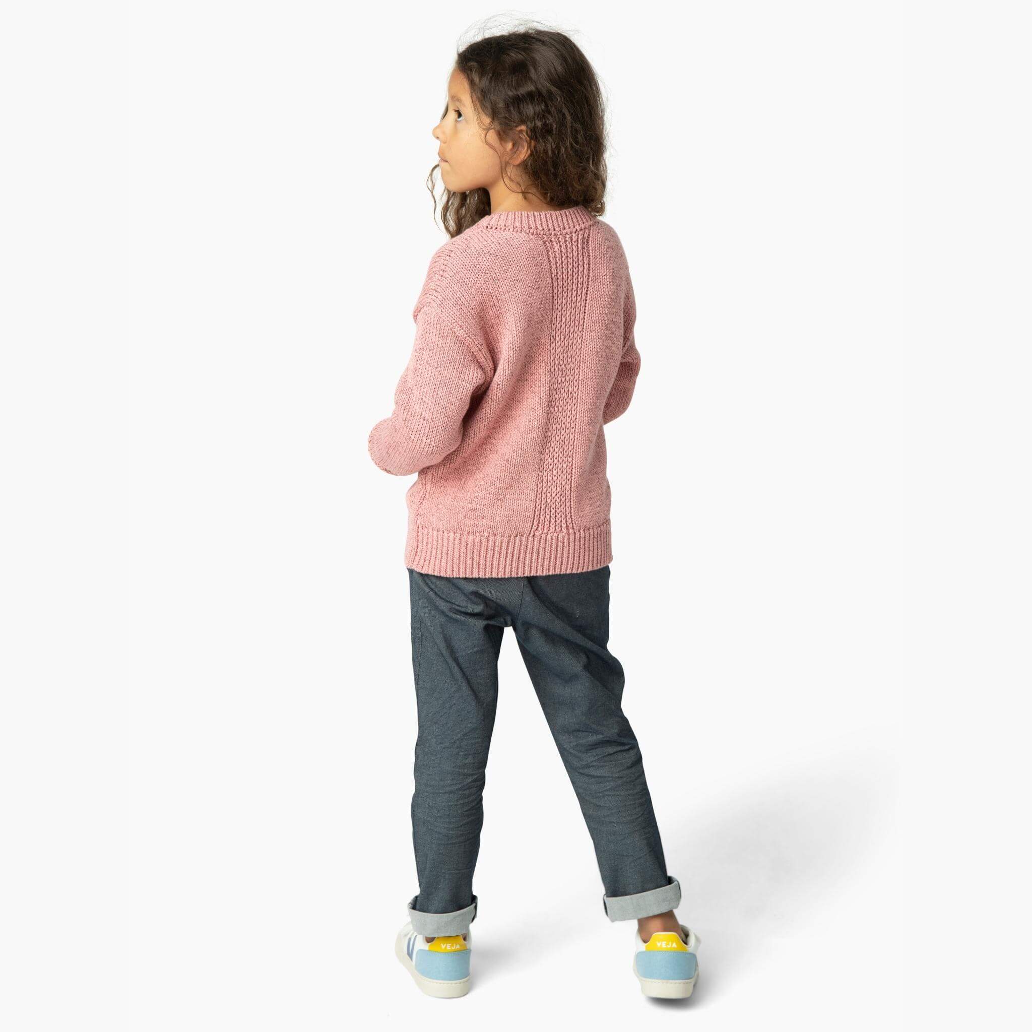 Girl wearing the perfect jean from our Kids Essentials collection (view from back). Soft Denim Pants in Dark Gray, cuffed for a polished yet hip look, made of 100% organic Japanese cotton
