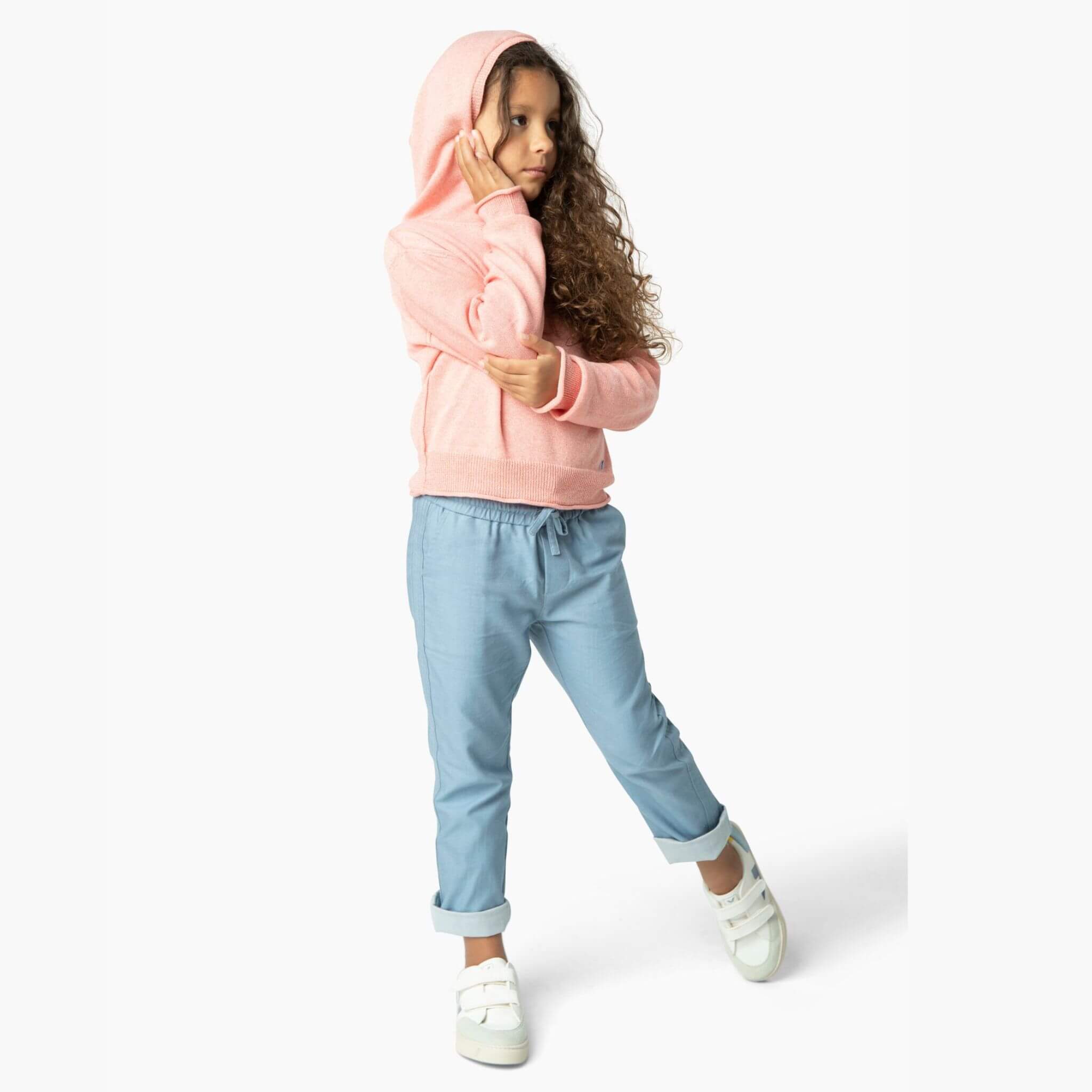Girl wearing light blue soft denim pants and one of our favorite girls sweaters from our Kids Essentials organic cotton collection.