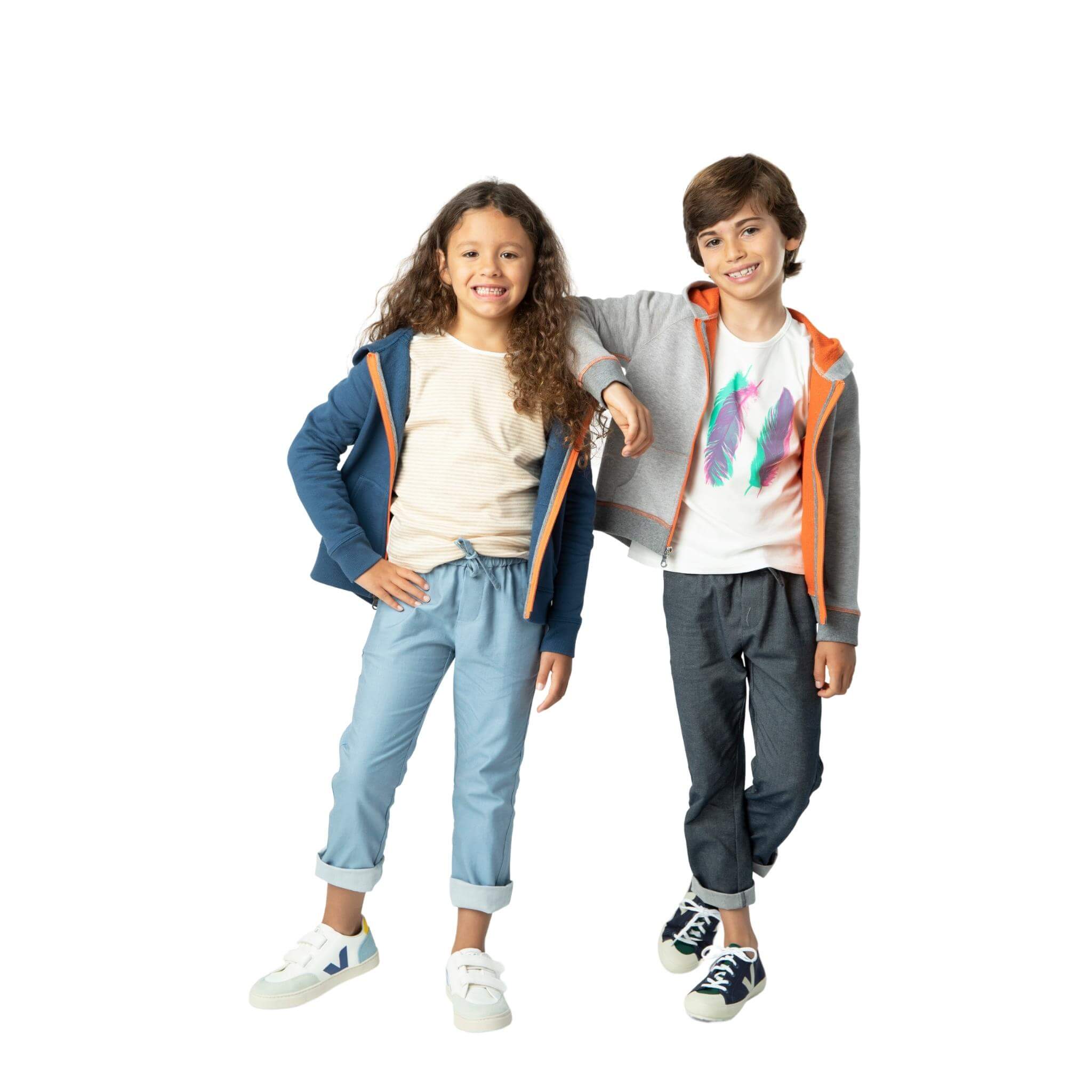 Boy and girl each wearing our soft denim pant and a Kids Essentials hoodie, made from organic cotton, showcasing sustainable and stylish fashion for children.